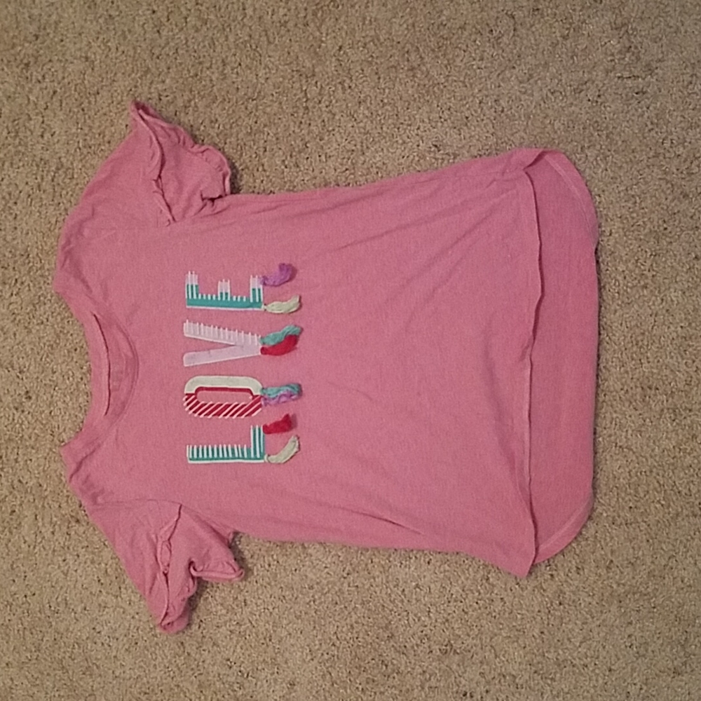 A pink shirt with the writing LOVE on the front